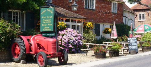 picture of the famous old tractor outside the Half Moon pub in Northchapel