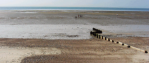 Low tide at Worthing beach leaves a huge expanse of sand for seaside holiday makers to enjoy Picture of a typical Sussex beach - ideal for a seaside holiday
